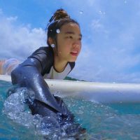 girl surfer swimming